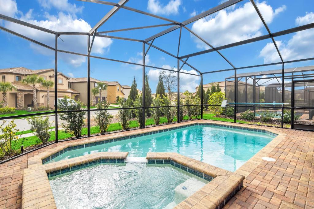 a swimming pool with a pergola next to a house at 5532 Misty Oak Circle in Davenport