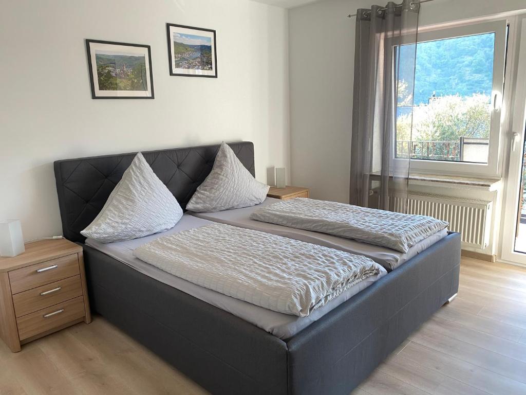 a bed sitting in a room with a window at Ferienwohnung Haus Jose in Cochem