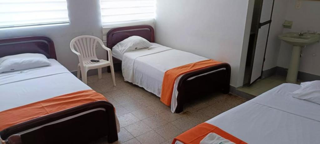 Postel nebo postele na pokoji v ubytování Hotel Tayrona