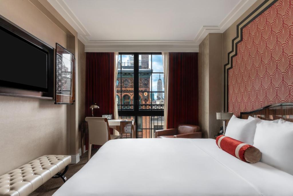 a hotel room with a large bed and a window at Walker Hotel Greenwich Village in New York