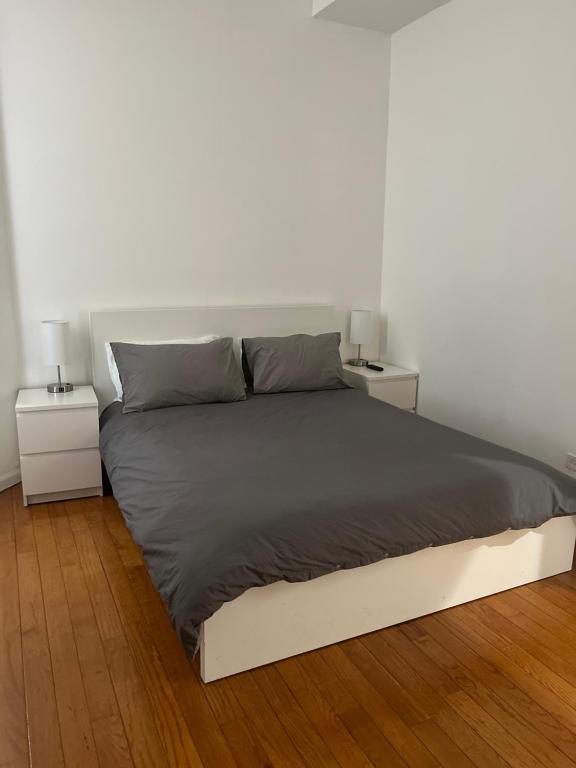 a bedroom with a bed with two night stands at Adorable 2 bedroom with free street parking in Chicago