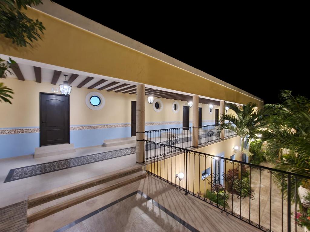 a balcony of a house with a black door at Hotel Fundadores in Valladolid