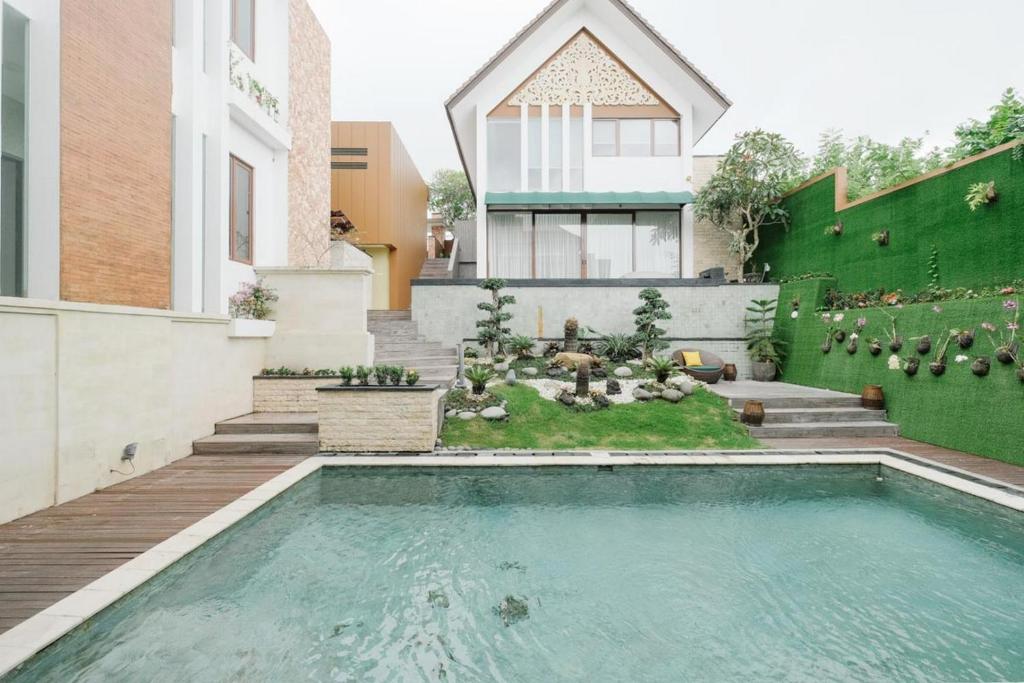 a swimming pool in the backyard of a house at Villa Maisha by The Lavana in Nusa Dua