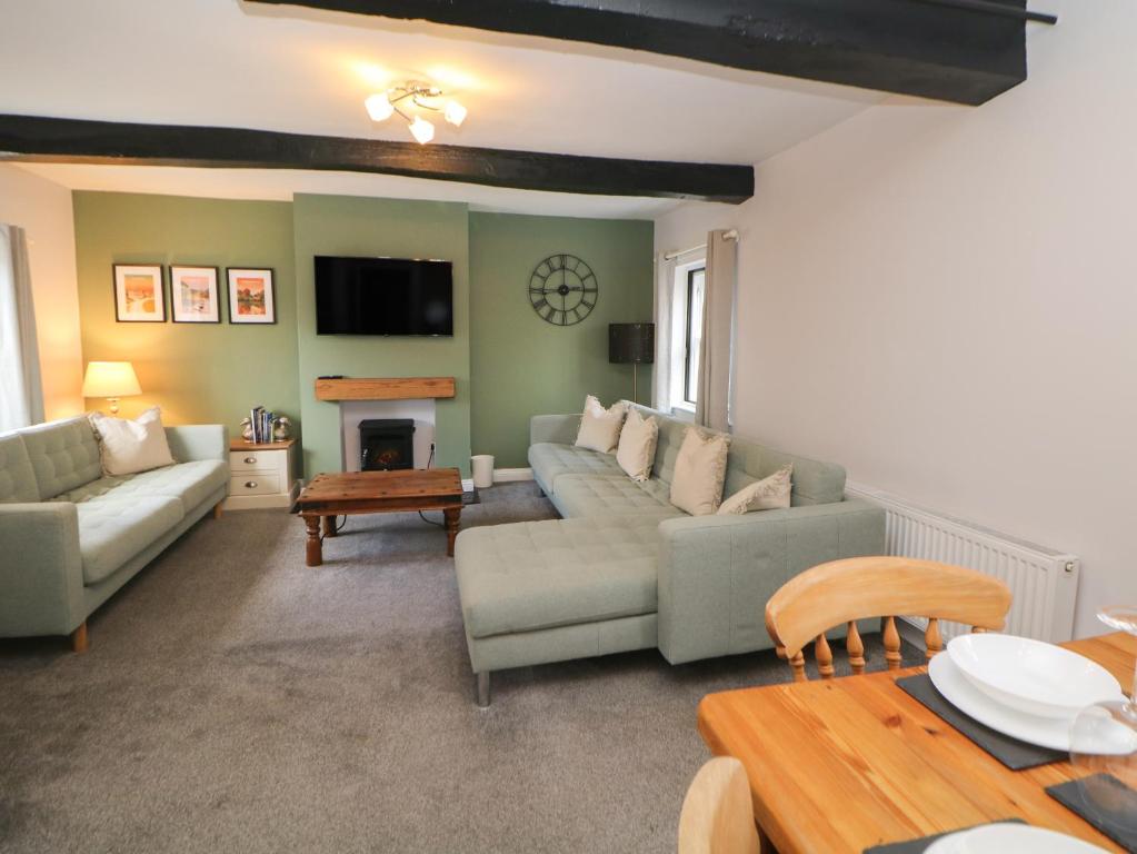 a living room with a couch and a table at Kennedy's Cottage in Ashbourne