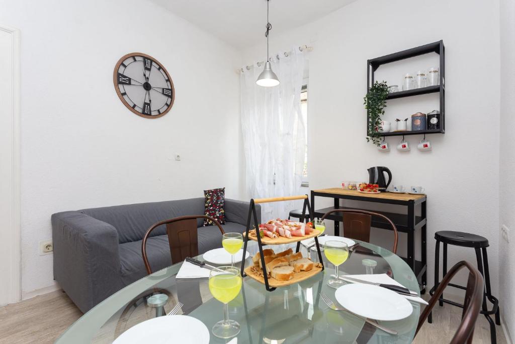 a living room with a glass table with food on it at Old Market Residence in Šibenik