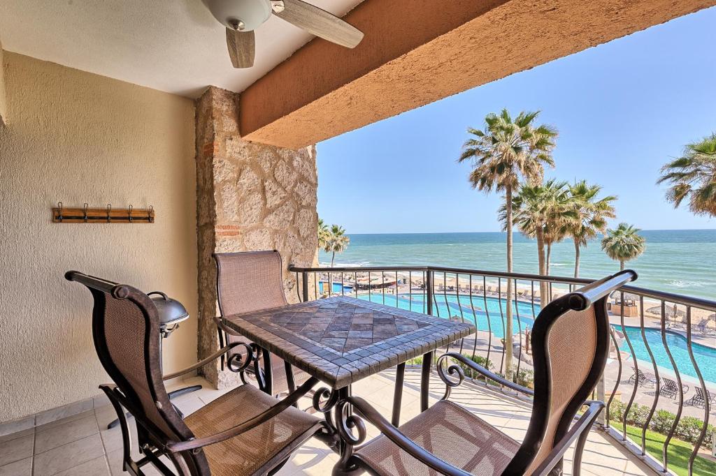 a balcony with a table and chairs and the ocean at Sonoran Sea 310-W - Modern 1 bedroom in Puerto Peñasco