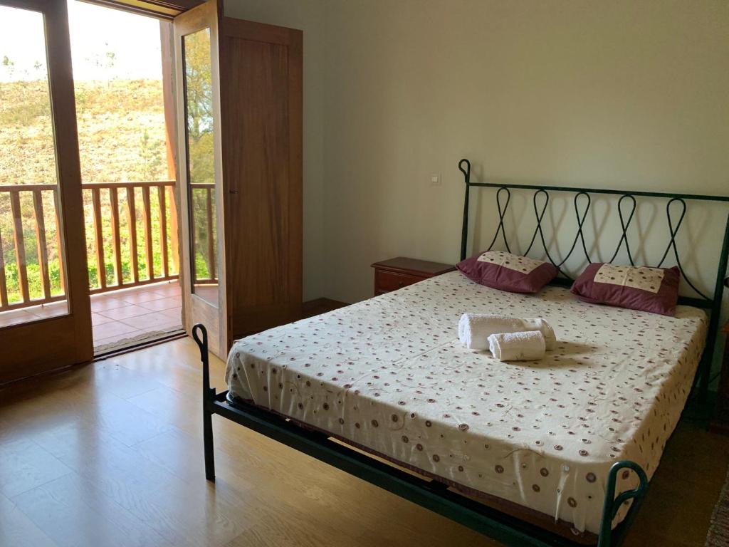 a bedroom with a bed with two pillows on it at Casa da Touça in Celorico de Basto