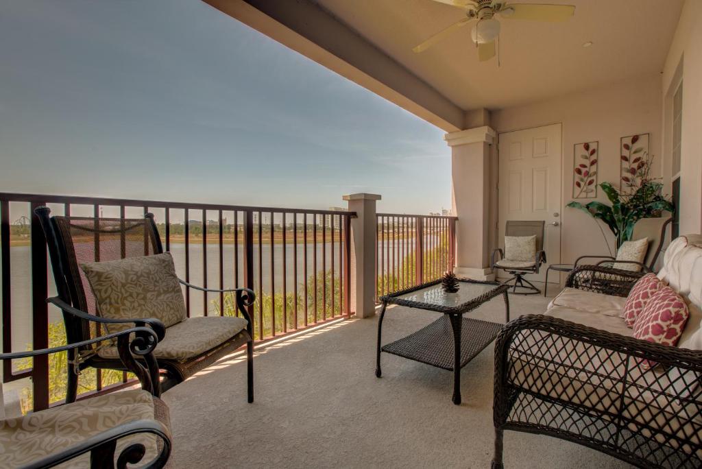 a screened in porch with chairs and a table at Lakeview Executive Penthouse in Orlando