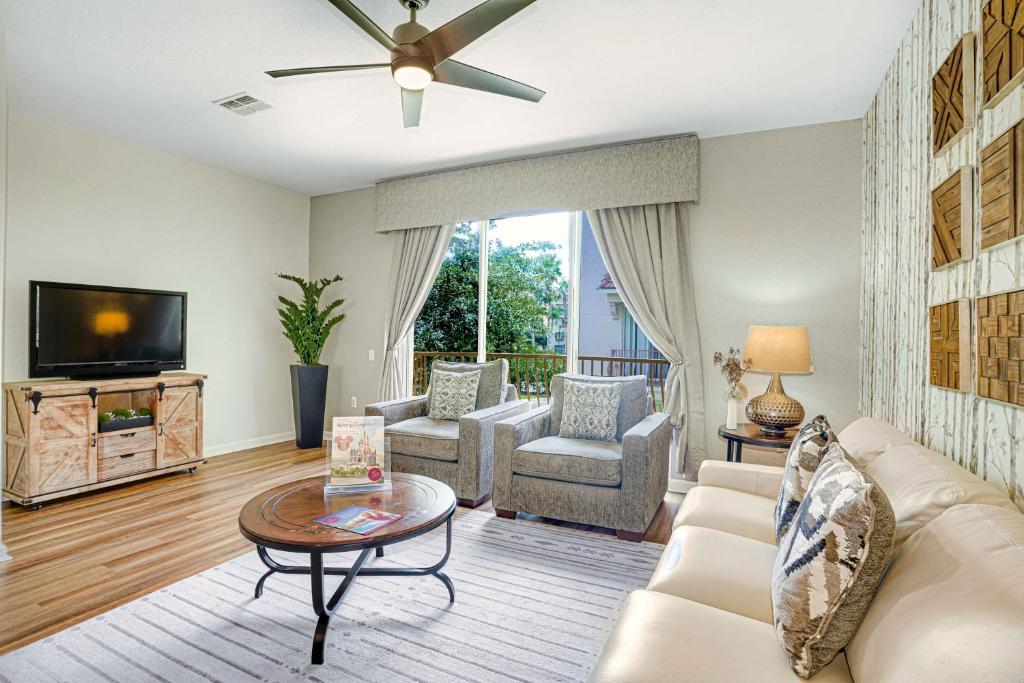 a living room with a couch and a tv at Spacious Townhome wPatio Garage Sleeps10 in Orlando
