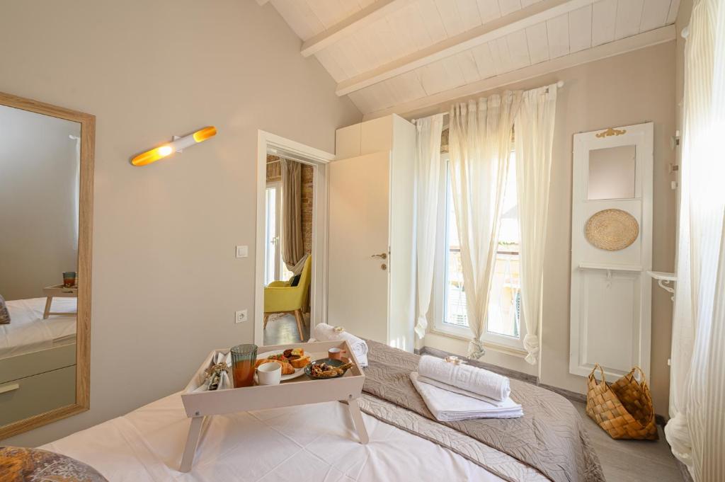 a bedroom with a bed and a table with food on it at Casa Iolanda II in Corfu