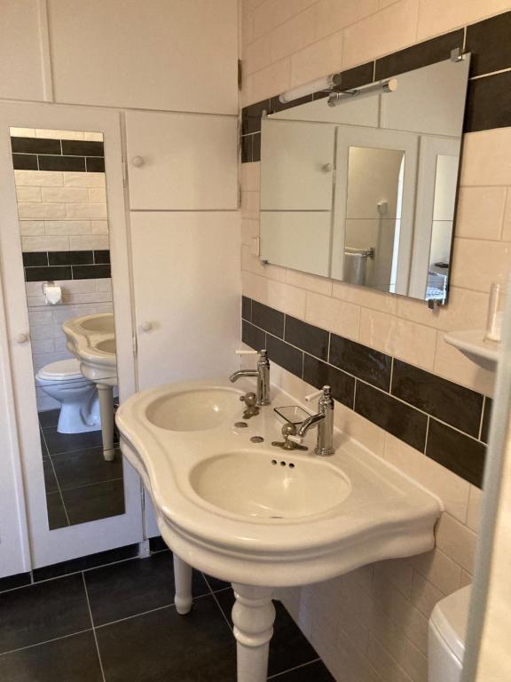 a bathroom with a white sink and a mirror at La maison du pech in Monteils