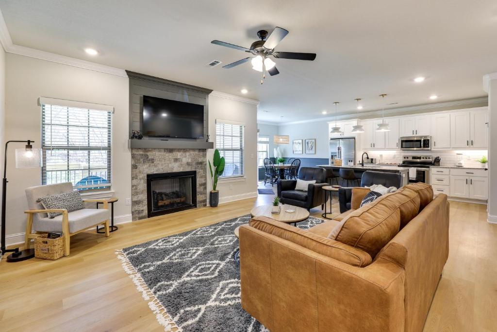 a living room with a couch and a fireplace at Biking Haven Charming Bella Vista Home with Games! in Bella Vista