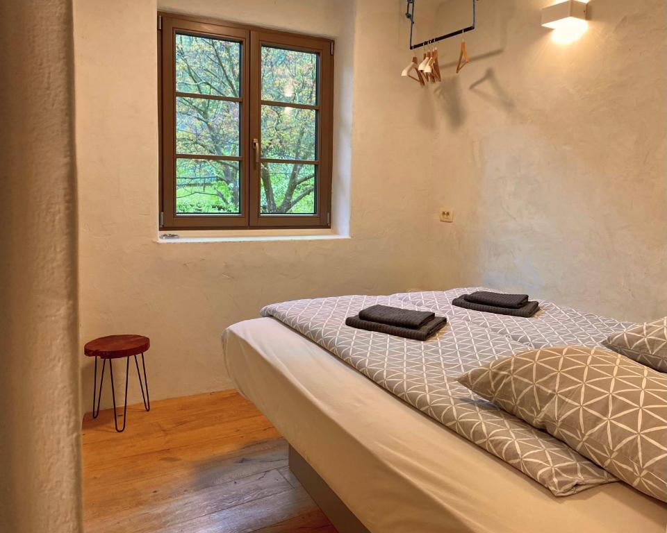 a bedroom with a bed with two towels on it at The Little Room in Bovec