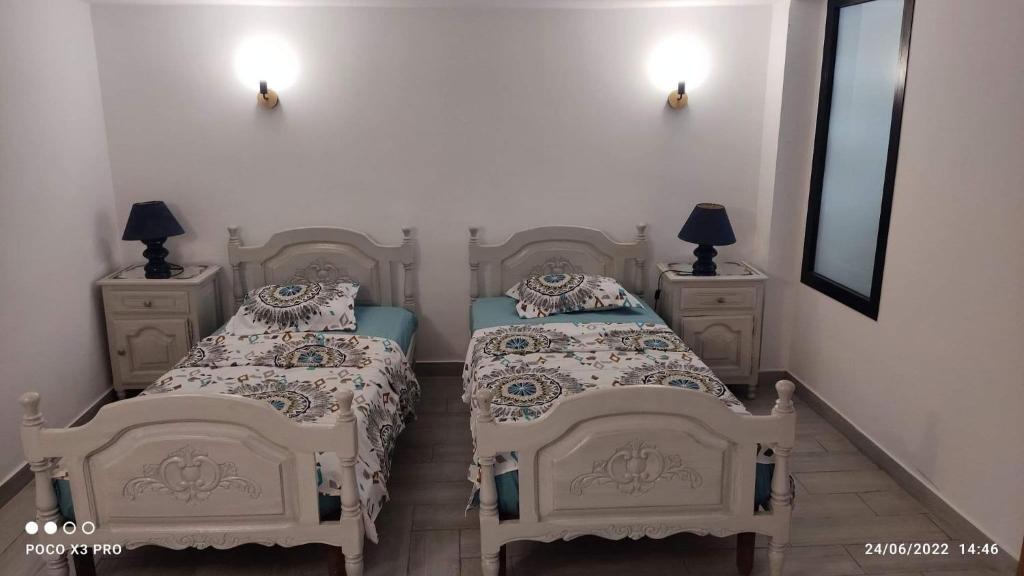 a bedroom with two beds and two night stands at Kelibia beach luxury maison in Kelibia