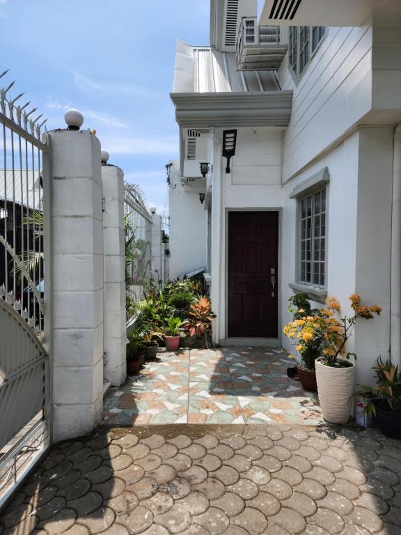 a walkway leading into a white house with a door at LUXURY HOME in Cotabato