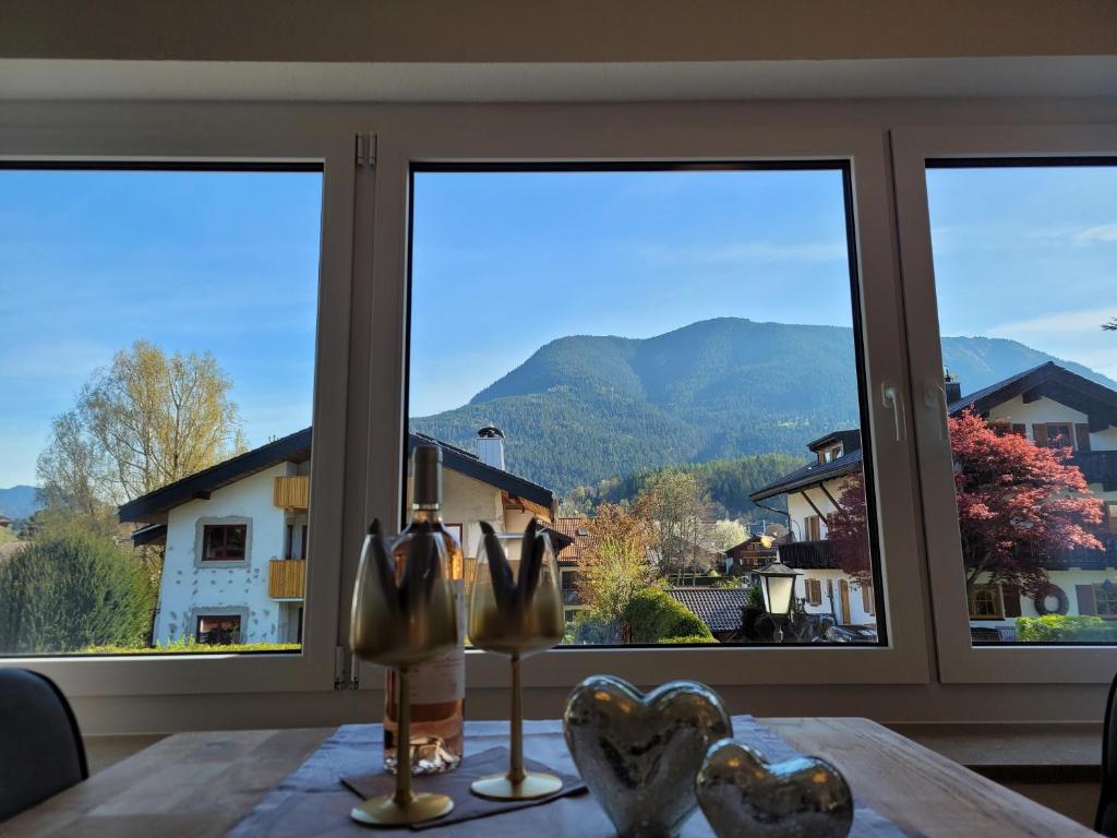 a dining room table with a view of a mountain at BERG-LOVE in Garmisch-Partenkirchen
