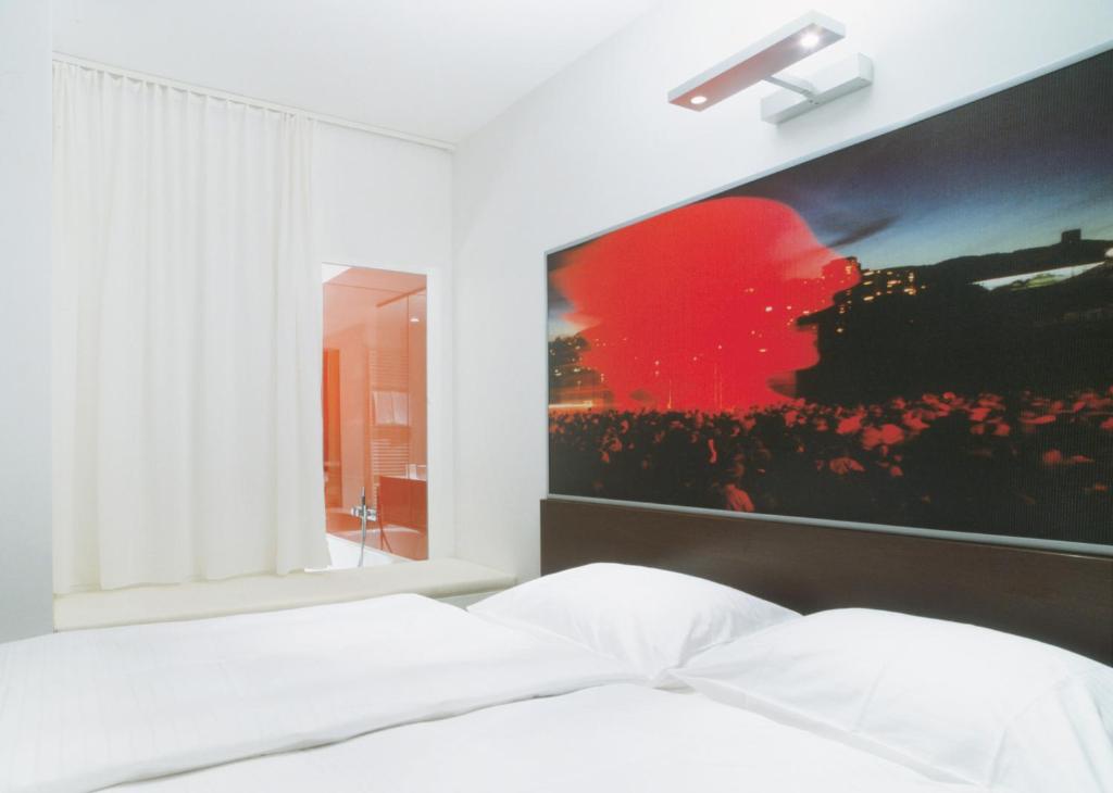 Postel nebo postele na pokoji v ubytování arte Hotel Linz