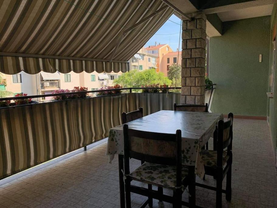 a table and chairs on a patio with a balcony at Apartment Chie in Izola