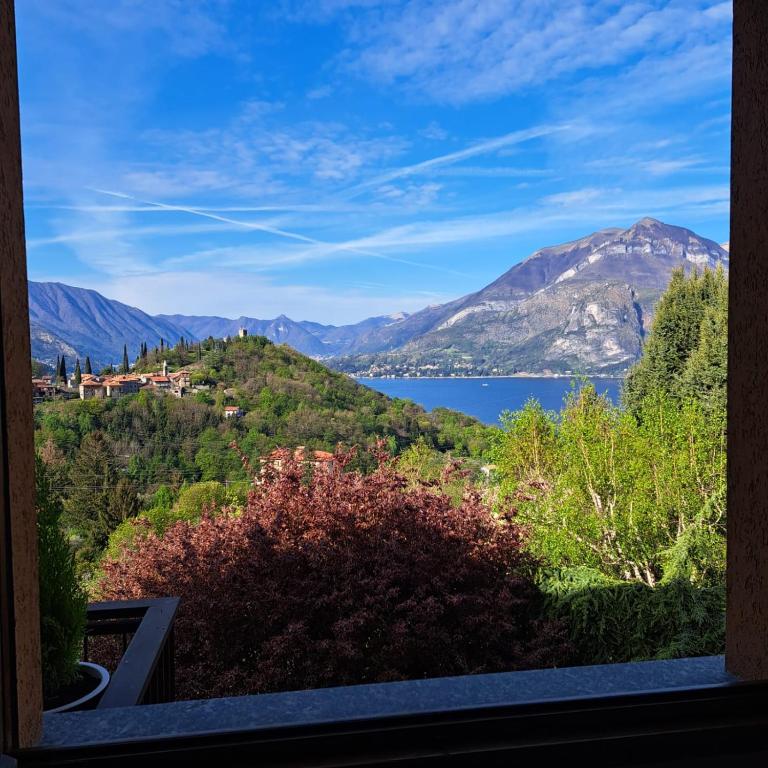 a view of a lake and mountains from a window at La casa di Camilla in Perledo