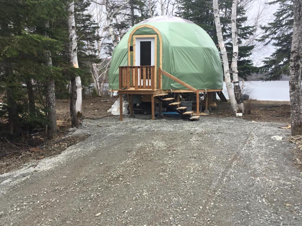 a green dome tent sitting in the woods at dôme près du lac in Saint-Narcisse-de-Rimouski