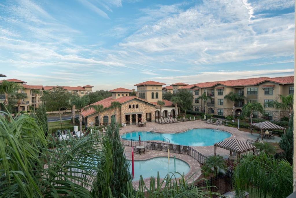 an aerial view of a resort with a swimming pool at Ground floor condo, no carpet, close to community pools, fitness room, 9 miles to Disney World in Davenport