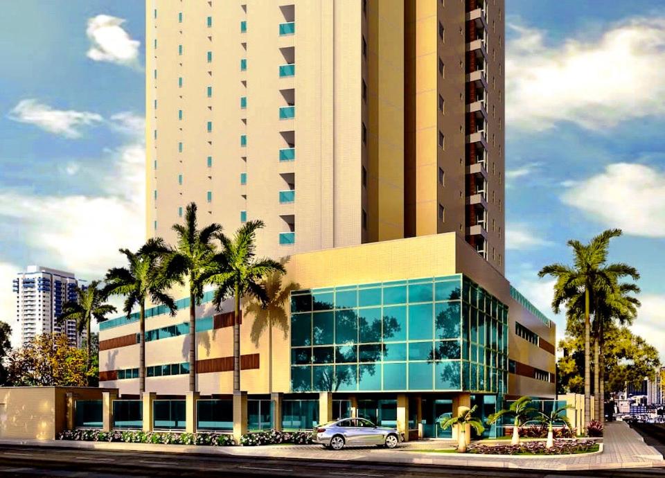 un gran edificio con un coche aparcado delante de él en Aquarius Residence en Fortaleza