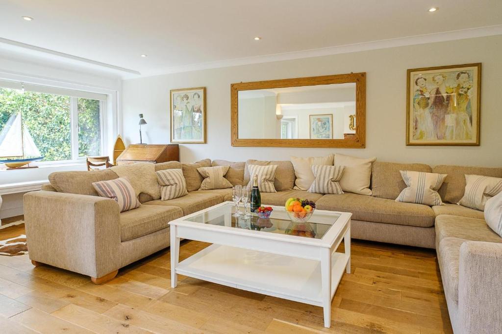 a living room with a couch and a table at Turret House, Thorpeness - Close to the beach, Thorpeness Lake , Thorpeness Hotel, Golf and Country Club - Aldeburgh Coastal Cottages in Thorpeness