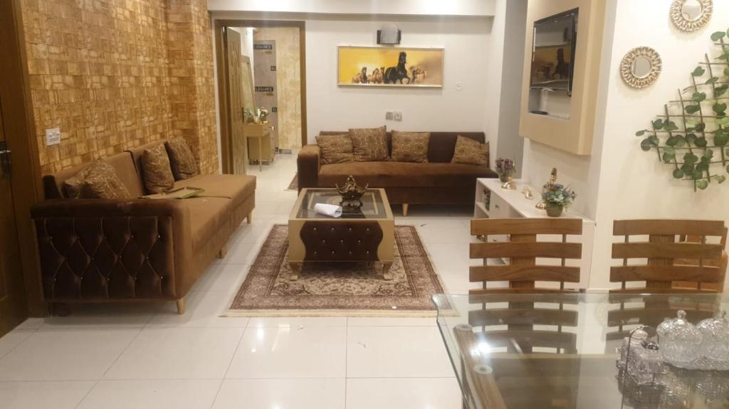 a living room with couches and a coffee table at AQZ Three-bedroom apartment in Islamabad