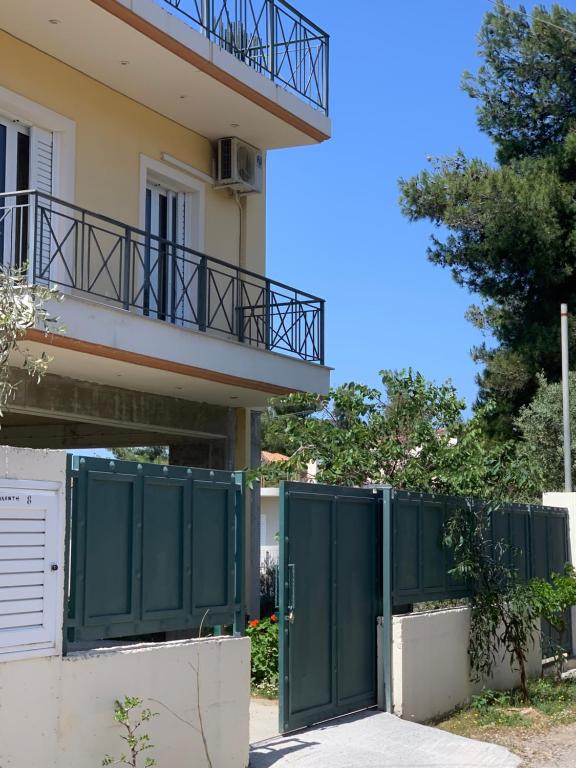a building with green gates in front of a building at Amazing view Panorama Eretrias in Eretria