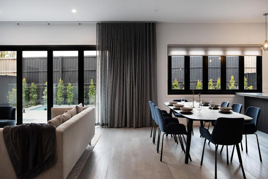 a living room with a table and a couch at Mysa Daylesford- stylish design with pool in Daylesford