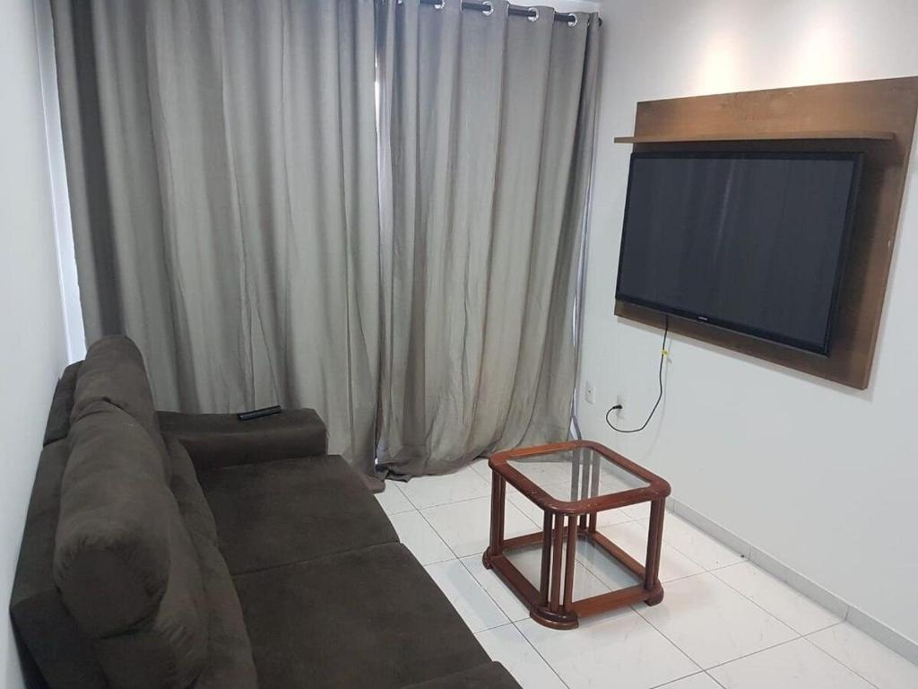 a living room with a couch and a flat screen tv at Monte Mulanje Home Service in João Pessoa