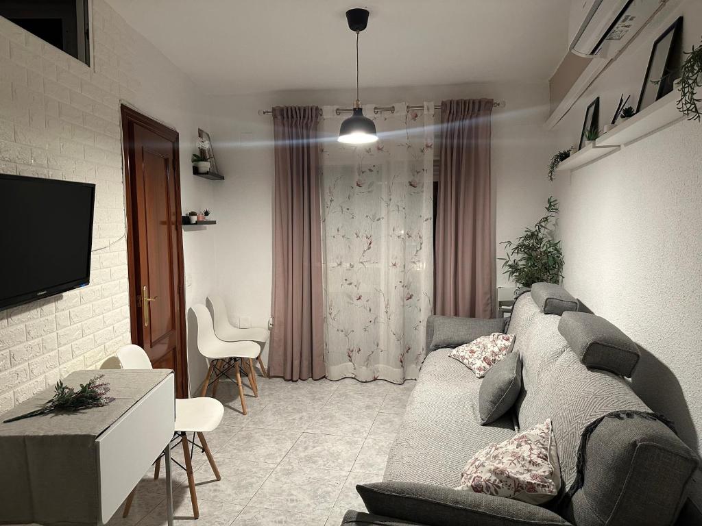 a living room with a couch and a tv at Apartamento en Paseo Larios de Torre del mar in Torre del Mar