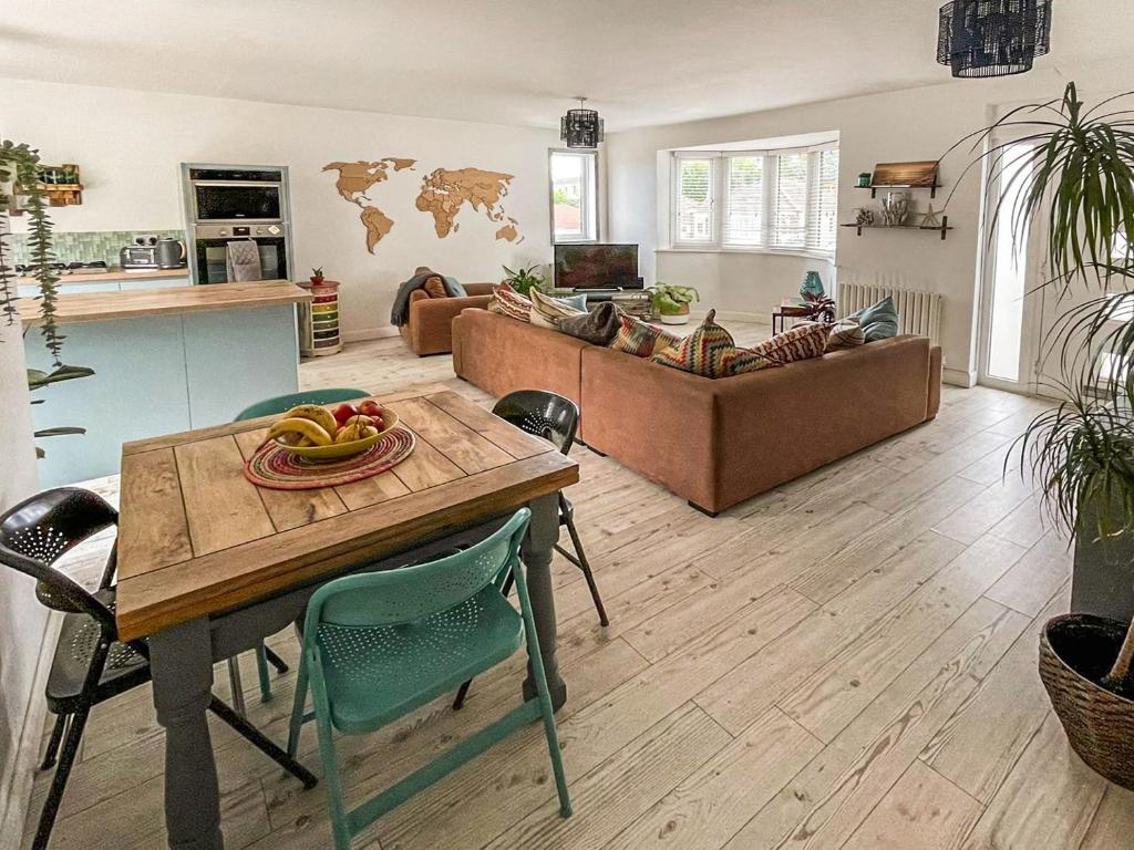 a living room with a table and a couch at Palm View in Paignton