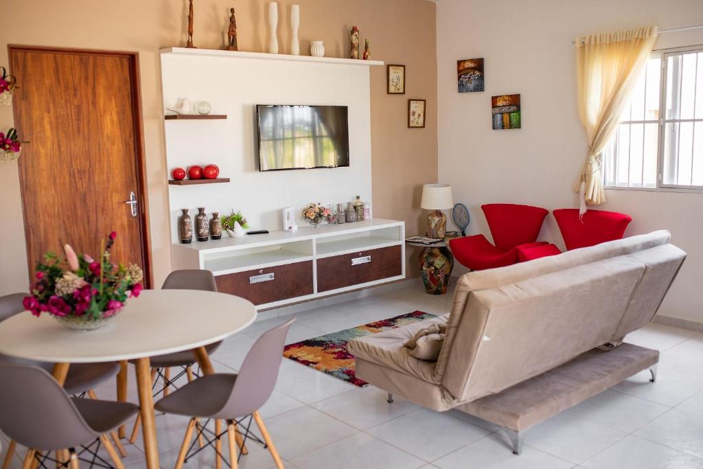 a living room with a couch and a table at Paripueira in Paripueira