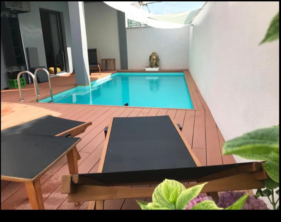 a swimming pool in the middle of a building at Apartments LOTA with heated pool on top location in Supetar