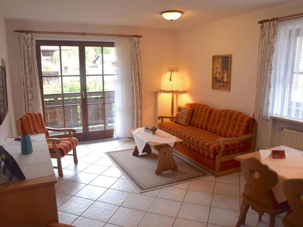 a living room with a couch and a table at Schönbrunn holiday home in Bayrischzell in Bayrischzell