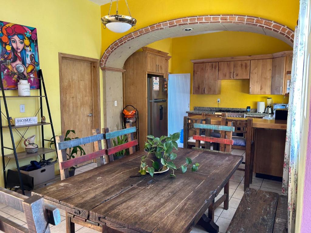 a kitchen with a wooden table in a room at Sofia Hostel Cabo in Cabo San Lucas