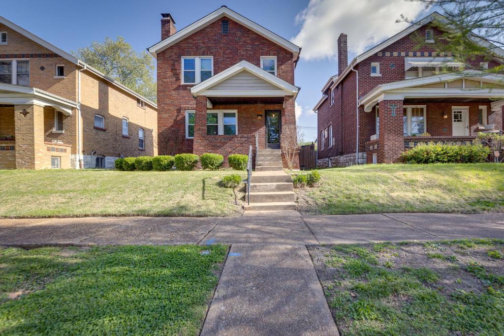 a large brick house with stairs leading to the front yard at Pet-Friendly St Louis Home with Grill and Backyard in Richmond Heights