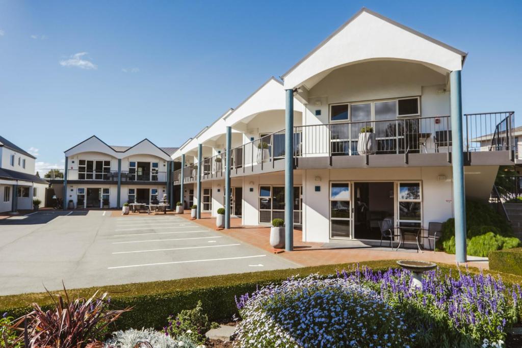 a view of the courtyard of a building with purple flowers at Radfords on the Lake in Te Anau