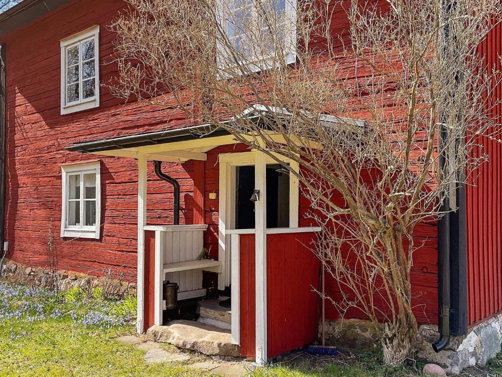 a red house with a red door and a red building at Holiday home Vingåker III in Vingåker