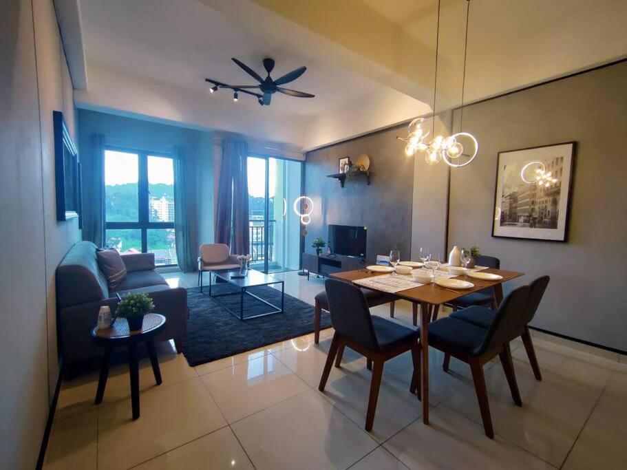 a dining room and living room with a table and chairs at Above Cameron Fair Mall @ Tanah Rata in Tanah Rata