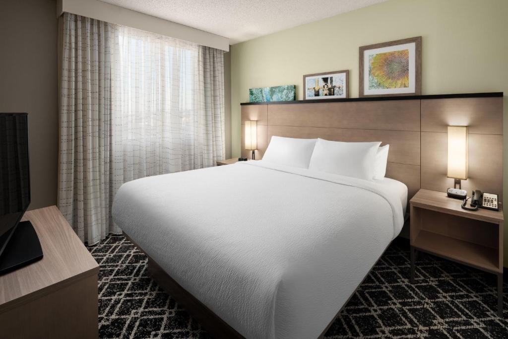 a hotel room with a large bed and a television at Residence Inn Portland Downtown/RiverPlace in Portland