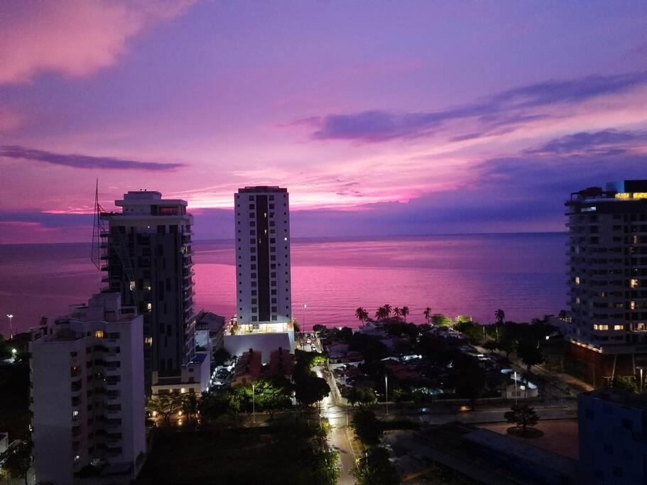 a city skyline at night with the ocean and buildings at El Samario Cumbia Host-Playa Salguero- Santa Marta in Gaira