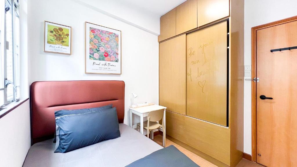 een kleine slaapkamer met een blauw kussen op een bed bij Shared Apartment Lockhart Road 384 in Hong Kong