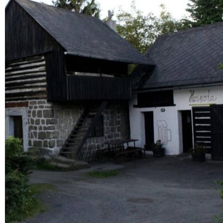 a stone building with a staircase in front of it at Apartmán Roubenka na Dobřeni in Mělník