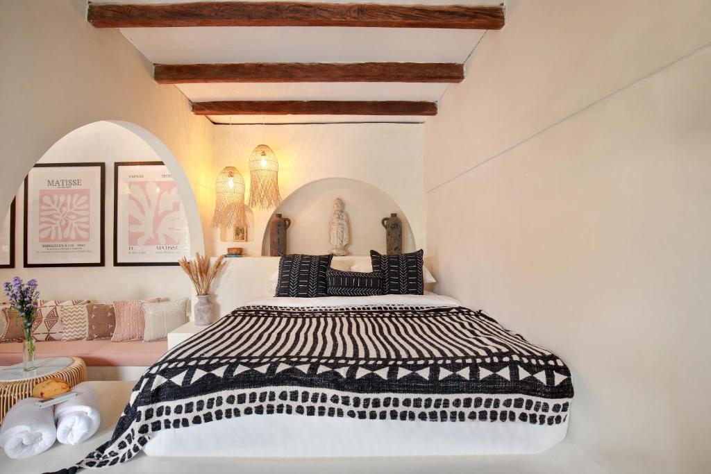 a bedroom with a bed with a black and white comforter at Seminyak Beach Bungalow Studio Villa 1 with private pool SBB1 in Seminyak