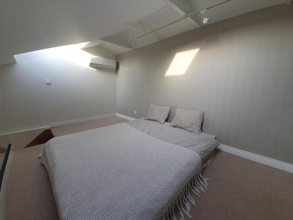 a small room with a bed in the corner at The Most Central Apartment in Kaunas