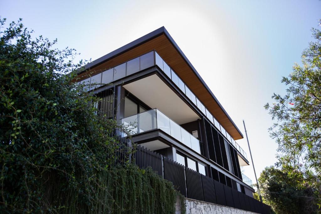 a modern house with a black fence at The Horizon Apartments by Urban Rest in Sydney