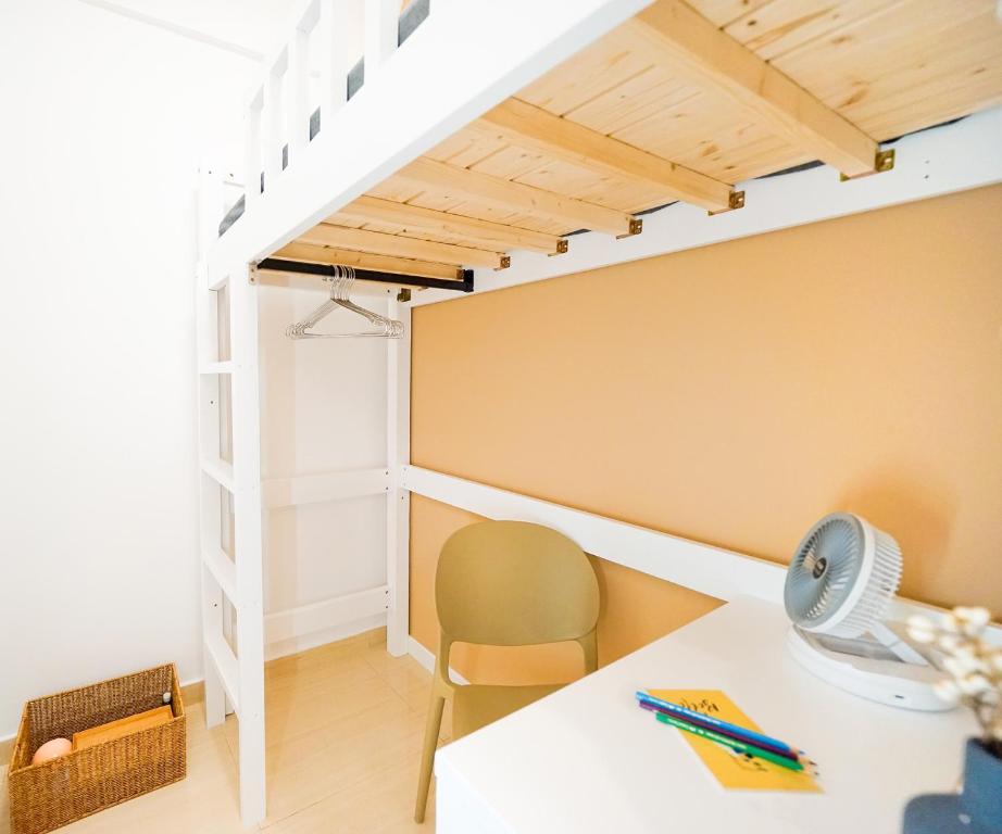 a room with a desk and a loft bed at Shared Room at Lockhart Road 414 in Hong Kong