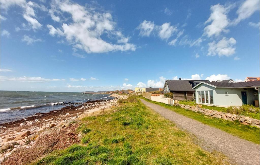 a house on the shore of a rocky beach at Lovely Home In Nyhamnslge With House Sea View in Nyhamnsläge